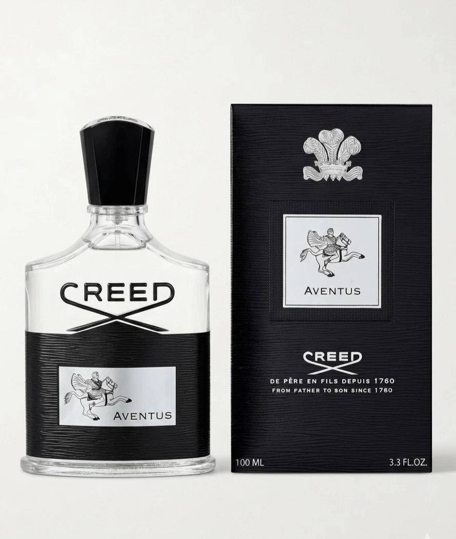 Creed Aged Oak Wood Eau de Toilette bottle with a black cap next to its black packaging box, both featuring the classic silver and white logo.