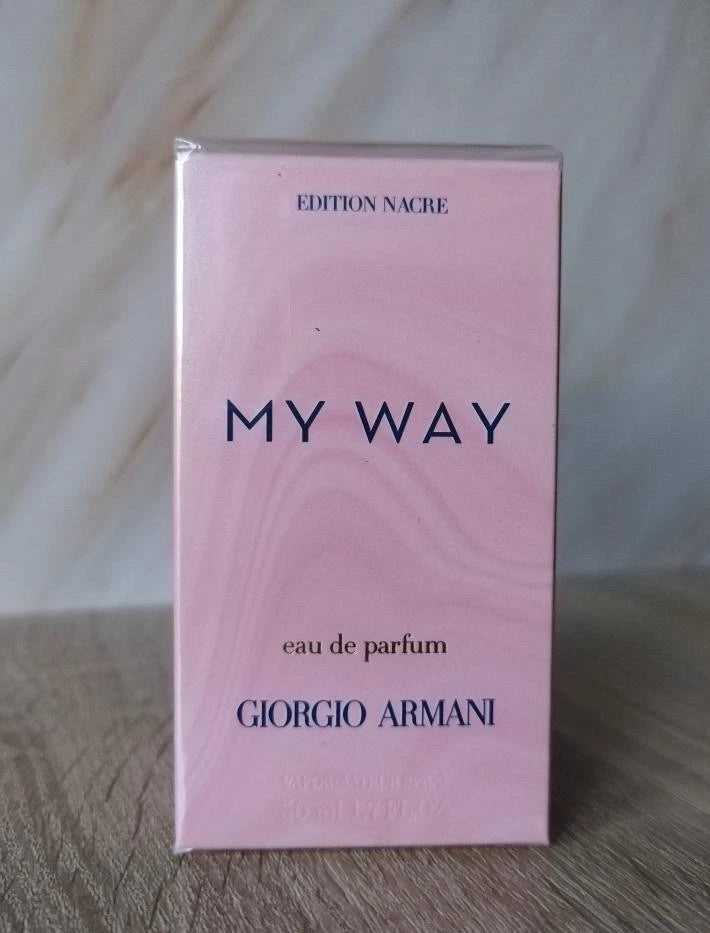 Giorgio Armani My Way Eau de Parfum box in Edition Nacre, featuring a light pink marbled design with dark blue lettering, standing on a wooden surface.