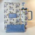 Stanley mug with floral design and matching pouch on a white background